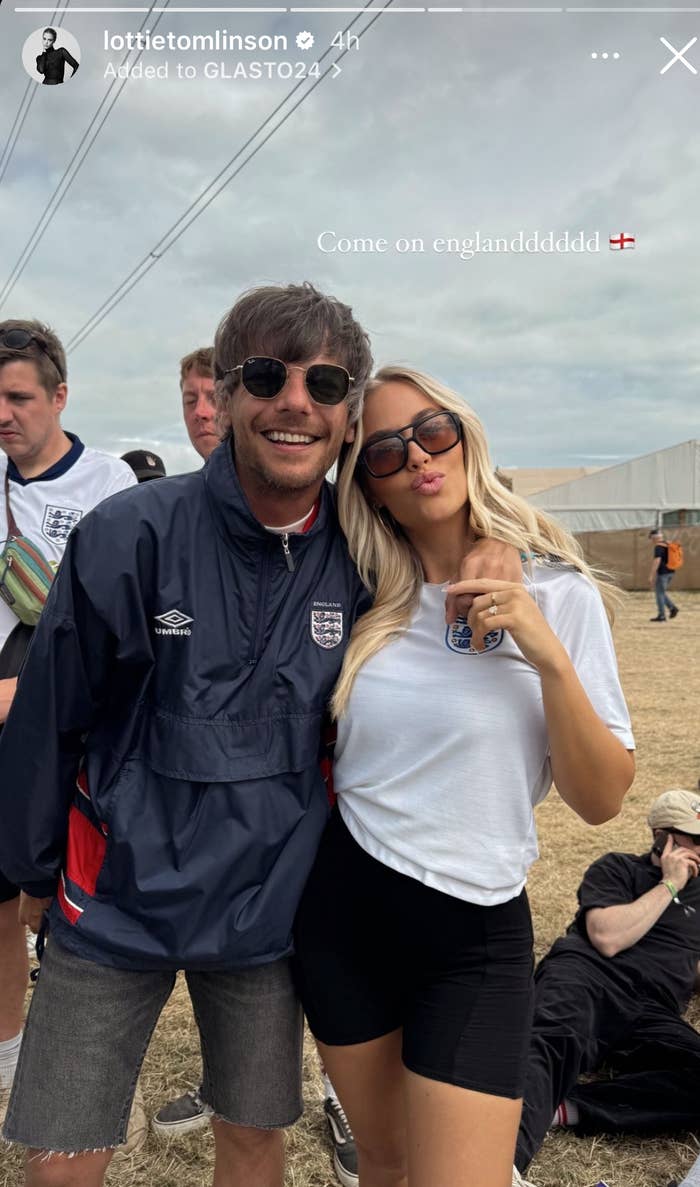 Louis Tomlinson and Lottie Tomlinson pose together; Louis wears a casual England jacket and Lottie a white t-shirt, black shorts, and sunglasses