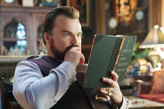 Jack Black reading a book titled 