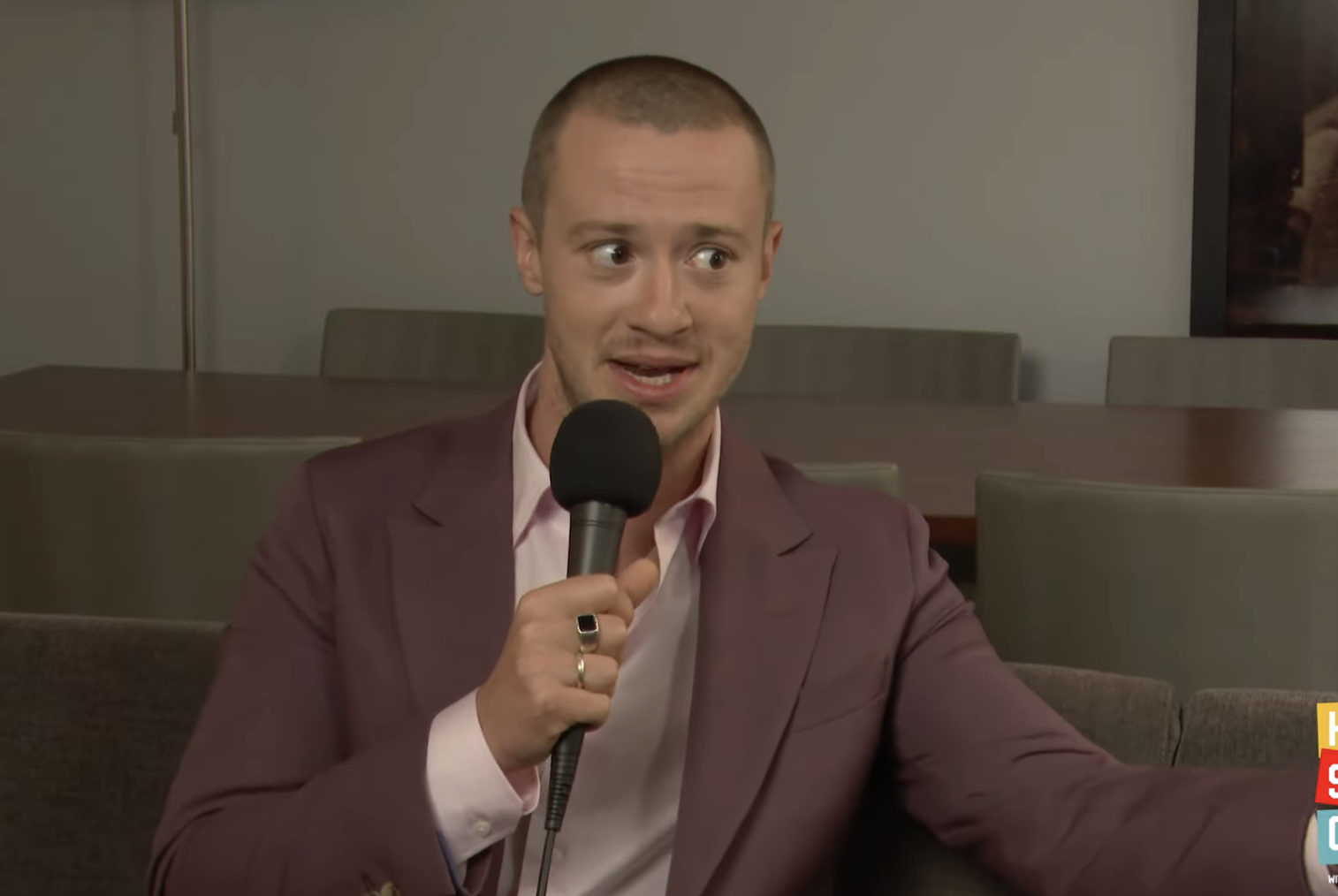 Joseph Quinn in a suit jacket during a YouTube interview